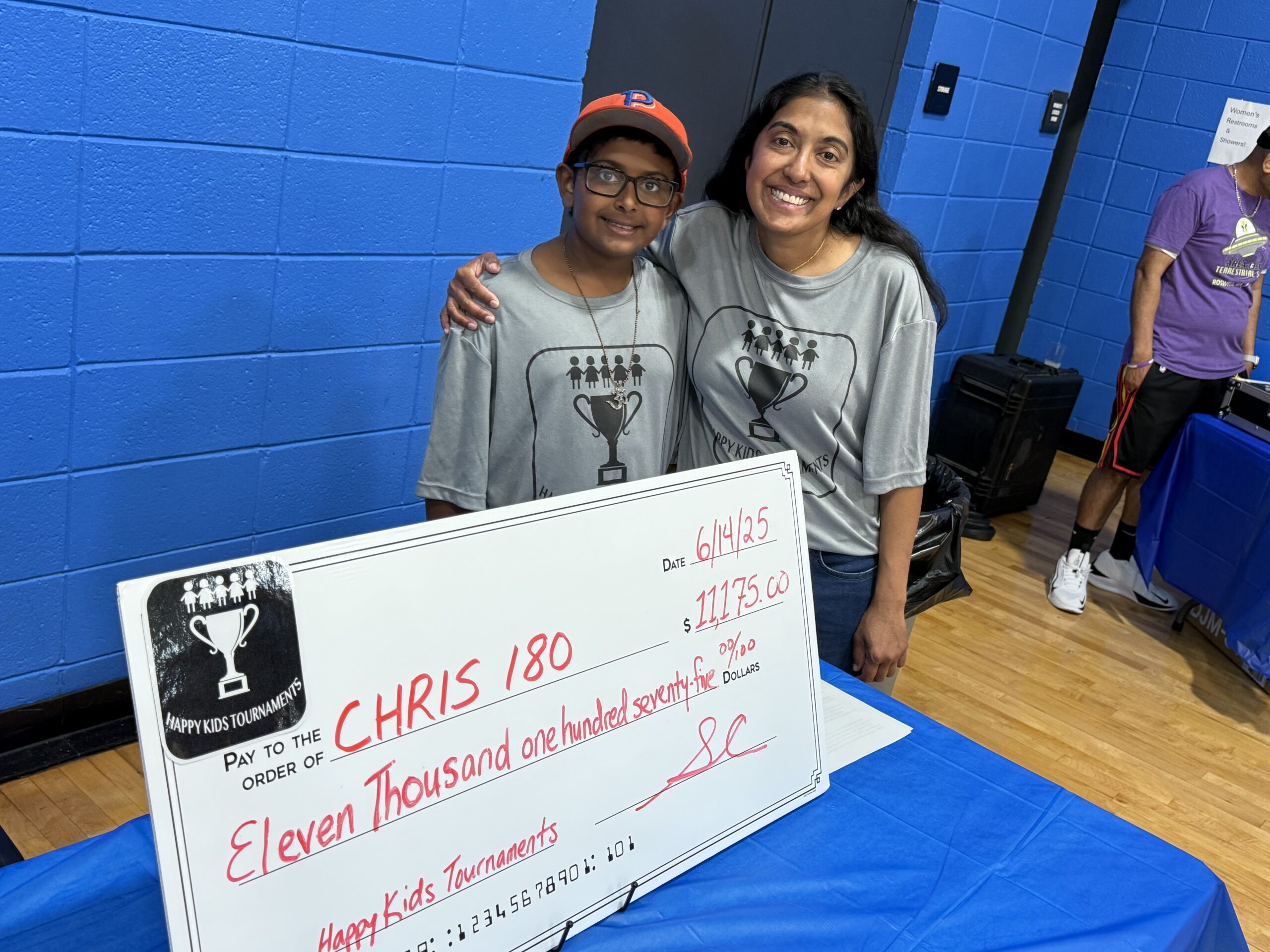 Dr. Dhruti Contractor and her son presenting the check to CHRIS180